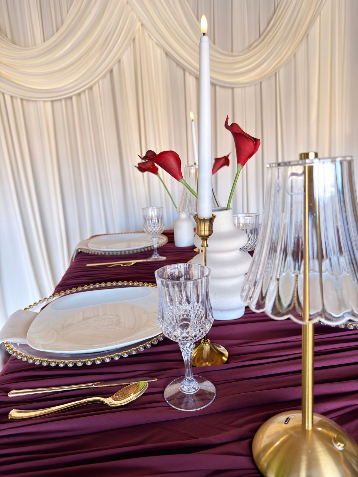 Styled table with candles and red napkins by Penbaga Events