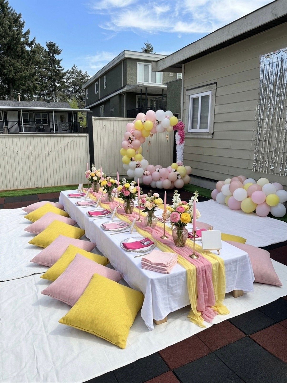 Picnic with pink and yellow balloon arch