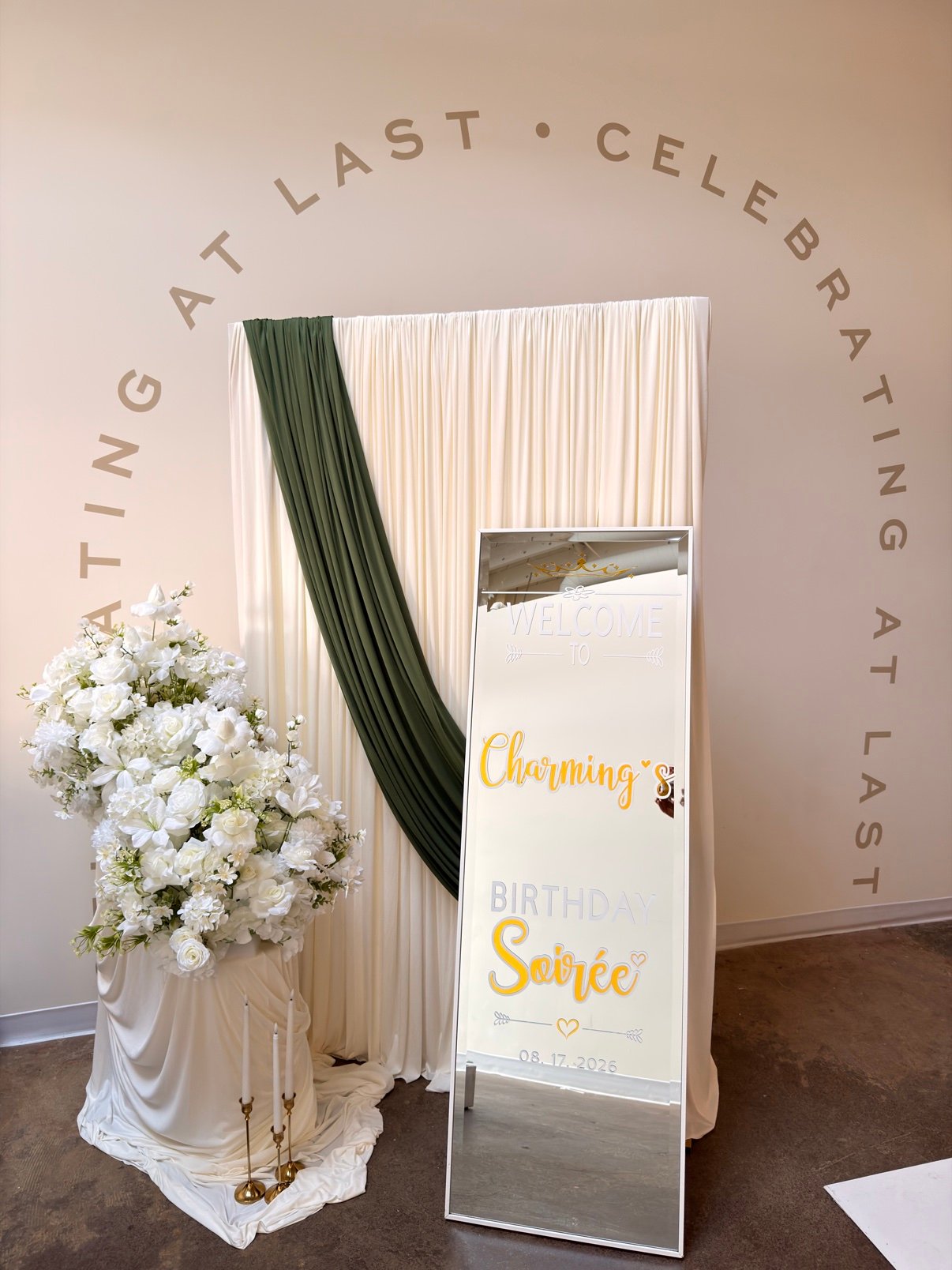 Welcome sign backdrop with white drapes and florals by Penbaga Events