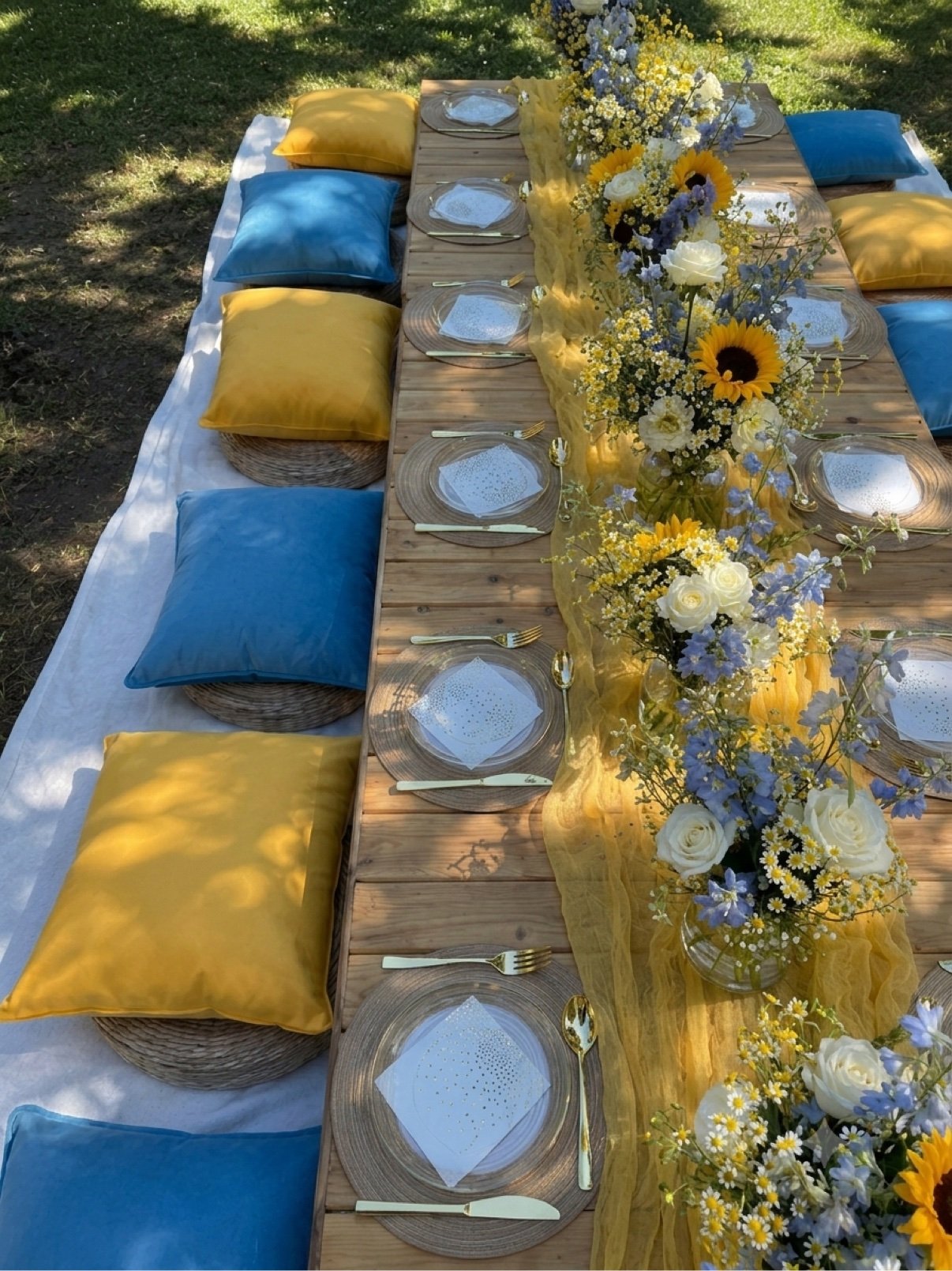 Luxury picnic setup with sunflowers, aerial view