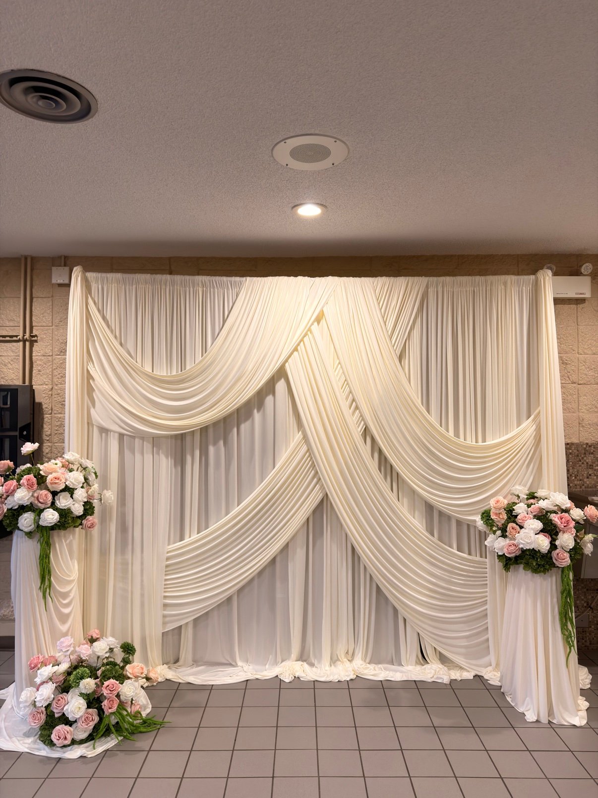 Elegant white draped backdrop wall by Penbaga Events