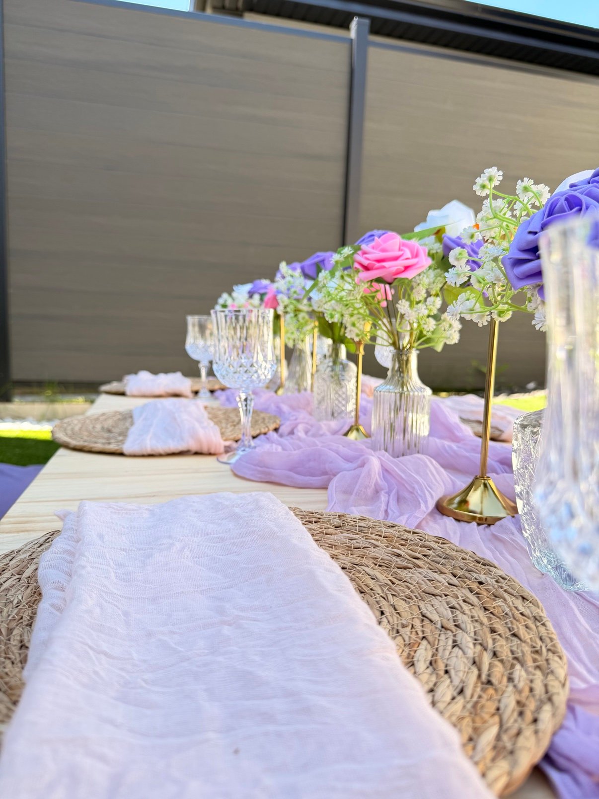 Close-up of purple and pink picnic table setting